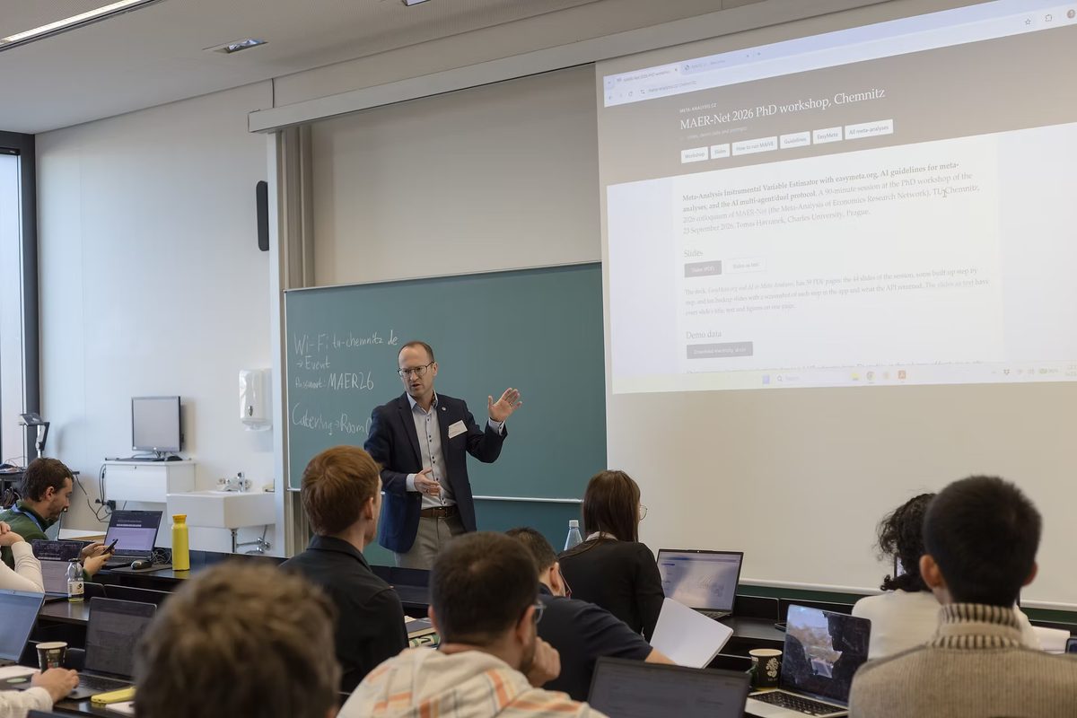 Tomas Havranek presenting at the MAER-Net 2026 PhD workshop at TU Chemnitz, with this page projected on the screen behind him